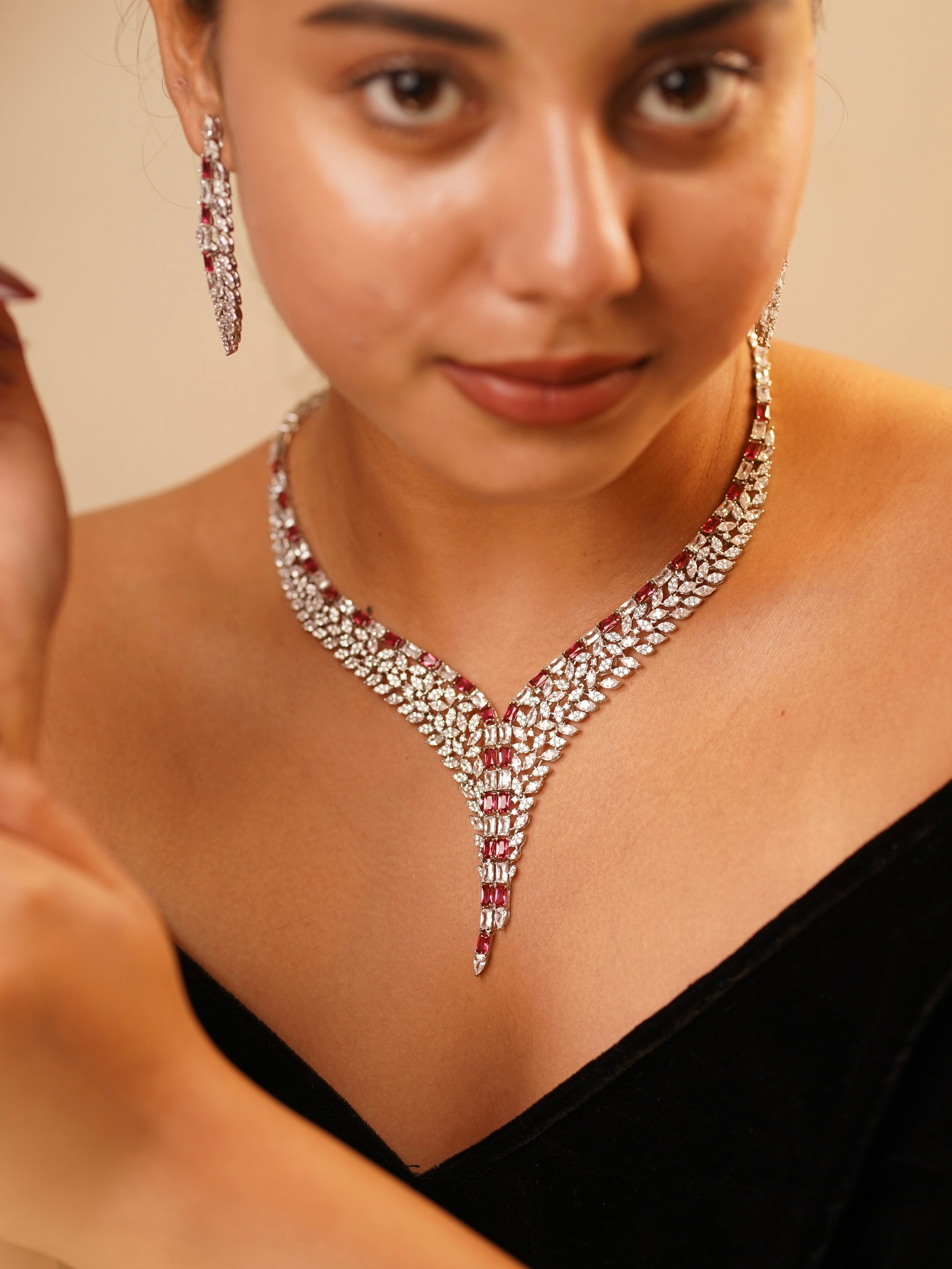 Ivy-inspired necklace set with vine-shaped diamond and emerald arrangement